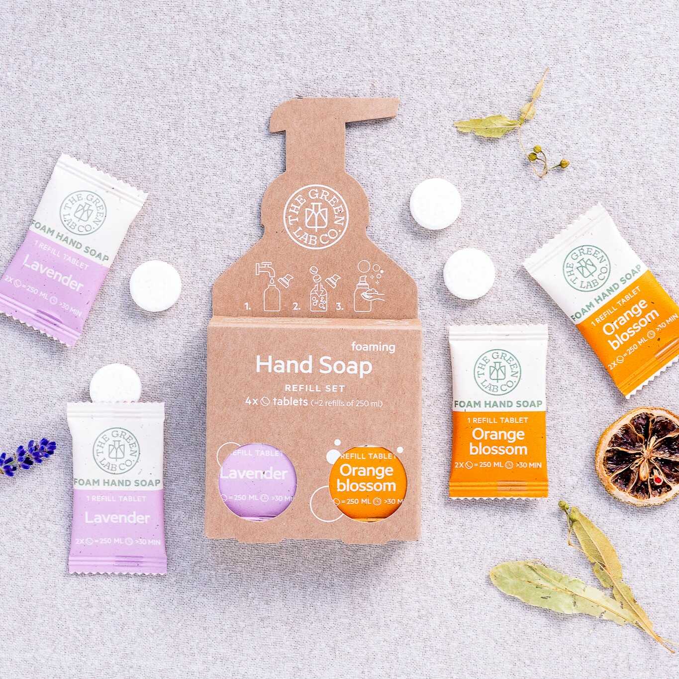 The Green Lab Co foaming hand soap refill set—Lavender & Orange Blossom tablets on a light fabric background.